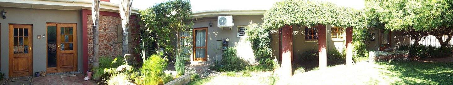 Panorama of the garden and guest room doors