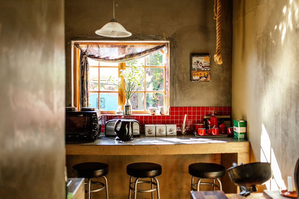 Kitchenette with a window, counter and bar stools