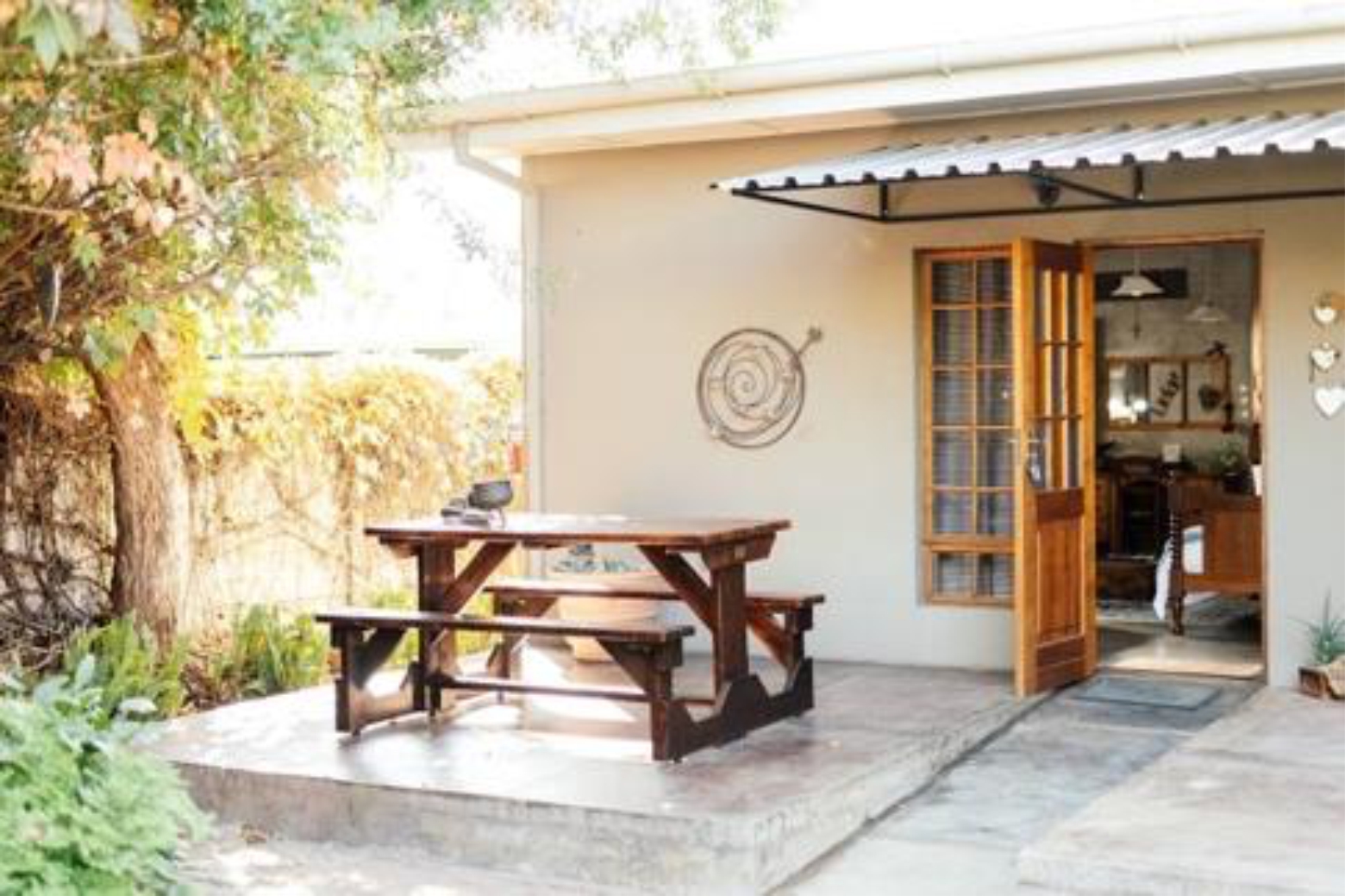 Patio with a picnic table and open French doors